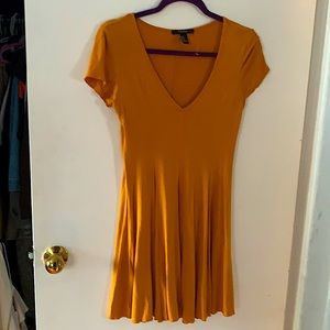 Mildly worn flow dress. Mustard colored.